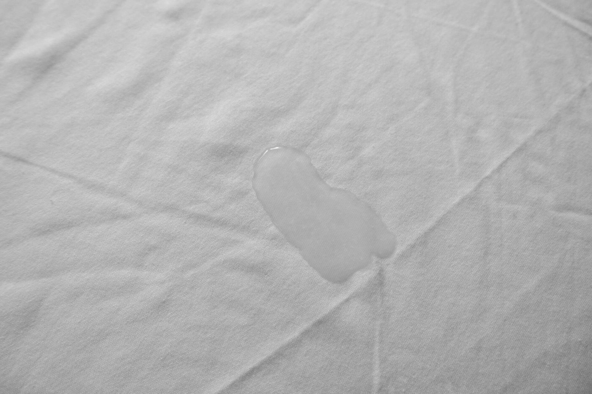 hypnia mattress protector with water on it